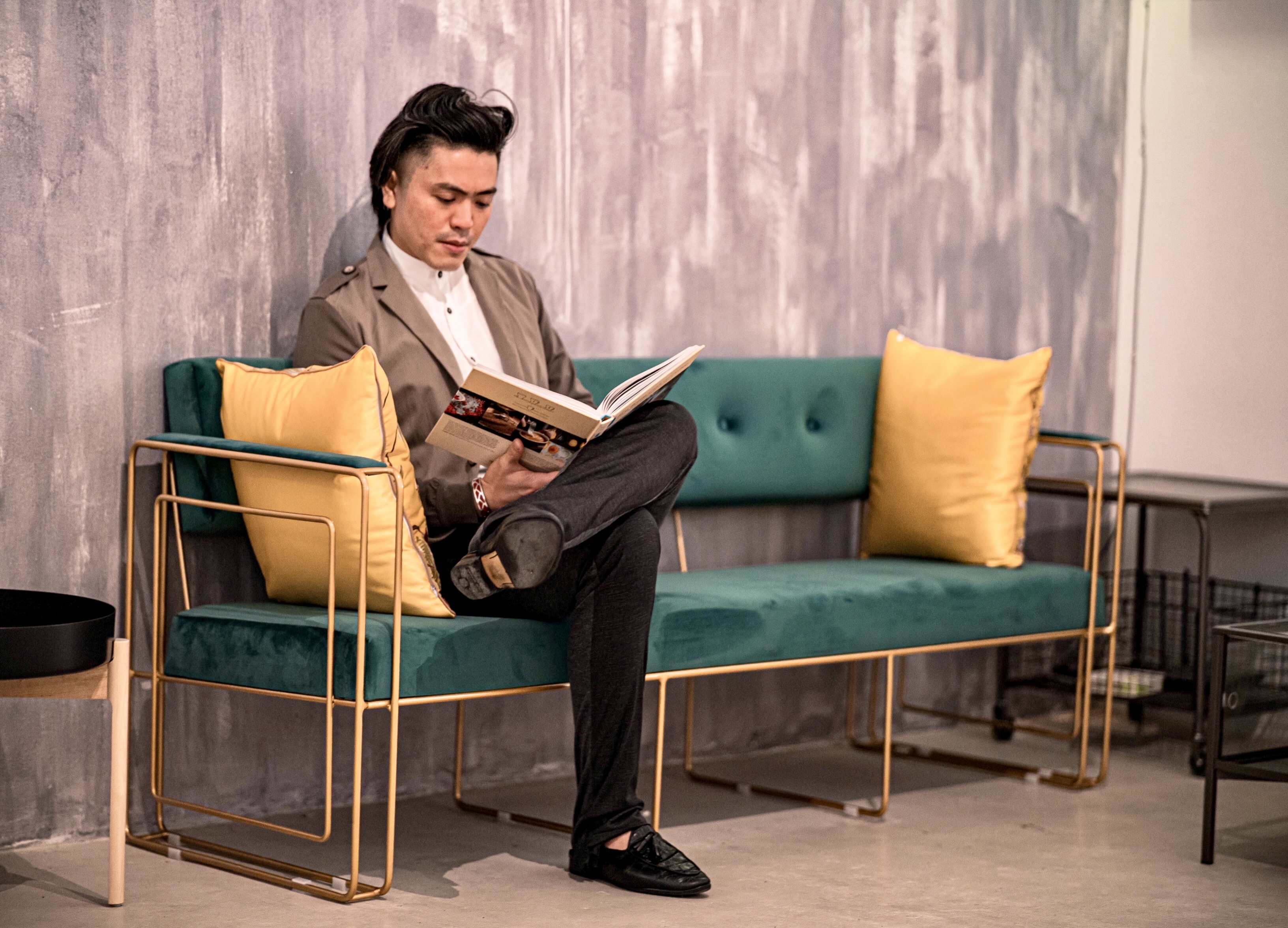 Dr Aaron Kwan standing beside a record player in a studio